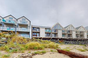 a large apartment building on the beach near the beach at On The Sand in Rockaway Beach
