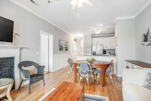 a kitchen and living room with a table and chairs at Marsh Winds 2K in Folly Beach