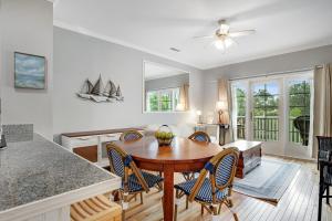 a kitchen and dining room with a table and chairs at Marsh Winds 2K in Folly Beach