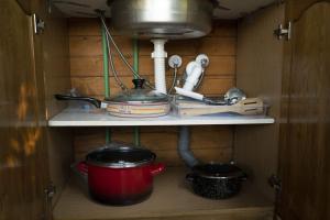 a kitchen shelf with a pot and other kitchen utensils at Super cute Treehouse by the river in Mostar +14 photos
