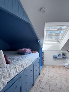 Un dormitorio azul con una cama y una ventana. en Casa Paz Lugo, en Lugo