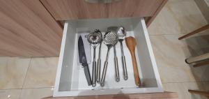 a white box with utensils in it at A few minutes from Siggrou Street in Athens +9 photos