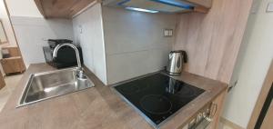 a kitchen with a sink and a counter top at A few minutes from Siggrou Street in Athens