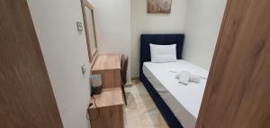 a small room with a bed and a mirror at A few minutes from Siggrou Street in Athens