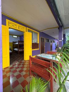 Una habitación con dos bancos y una puerta amarilla. en Casa Romano Hostel, en San Juan del Sur 37 fotos más