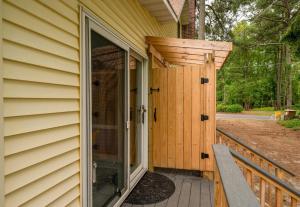 an entry to a house with a glass door at Whelks On Willow in Chincoteague +32 photos