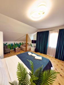 a bedroom with a large bed with a blue blanket at Hotel Tiflis Town in Tbilisi City