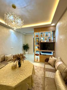a living room with a couch and a table at Afalux Brand chic in Agadir