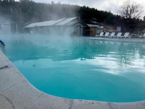 a pool of blue water in front of a building at Healing Waters Resort and Spa in Pagosa Springs
