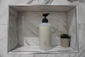 a bottle of soap sitting on a shelf in a bathroom at Ionian Blue Apartament 5 in Himare