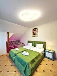 a bedroom with a large bed with two towels on it at Hotel Tiflis Town in Tbilisi City +86 photos