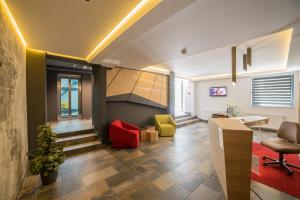 an office with a staircase and colorful chairs at Hotel Lux Divina in Braşov