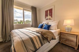 a bedroom with a bed and a window at Benwerrin House Fish Creek in Fish Creek