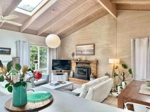 a living room with a table and a fireplace at The Vibe Sandy Point Stay 3 Pay 2 Winter Special in Sandy Point