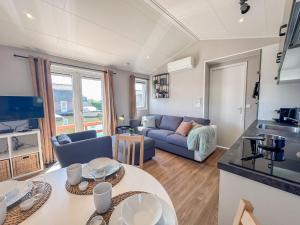 a kitchen and living room with a couch and a table at Fuut 24-28 in Breukelen +19 photos