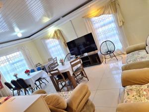 a living room with a table and a dining room at Salisha Bed & Breakfast in Maseru