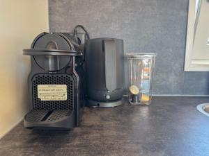 a kitchen counter with a coffee maker and a blender at Fuut 24-28 in Breukelen
