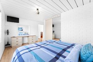 a bedroom with a bed and a desk at Apollo Unit 25 Ground Floor in Narooma +16 photos
