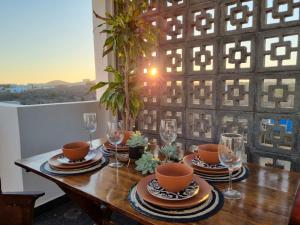 a table with plates and wine glasses on top of it at Casa Pacifico, Cerritos Beach in San Carlos +23 photos