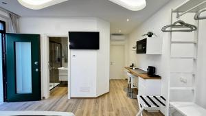 a white apartment with a black door and a kitchen at I Racconti del Fiume in Bussi sul Tirino
