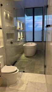 a bathroom with a toilet and a tub and a sink at Villa Bali in San Andrés +18 photos