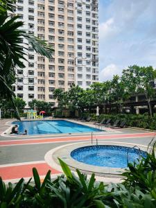a large apartment building with a large swimming pool at Casa Tagpuan in Manhattan ParkWay in Manila