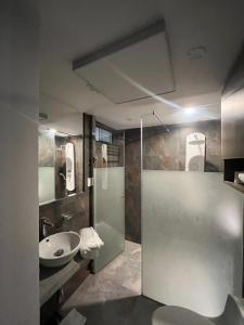 a bathroom with a sink and a glass shower stall at departamento en ica in Ica