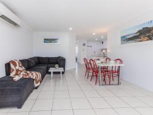 a living room with a couch and a table at Cabarita Beachfront Poolside 28 in Cabarita Beach