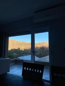a room with a view of a mountain through a window at La ola in Puerto Pirámides