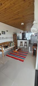 a living room with a couch and a kitchen at Casa Peninsula de Maraú in Marau