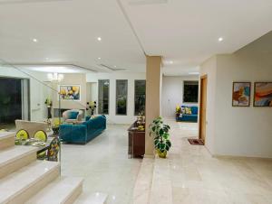a large living room with a blue couch at Villa in Meknès