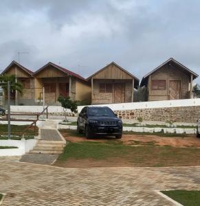 a black car parked in front of a house at Chalé Ventos da Serra in Serra de São Bento