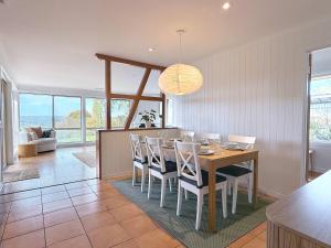 a dining room and living room with a table and chairs at 4BR Retreat Near McLaren Vale Wineries Adelaide in Clarendon