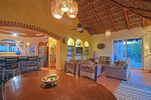 a kitchen and living room with a table and chairs at Ventana Bay Resort in La Ventana