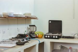 a kitchen with a counter with a stove and a blender at The Duck Dive El Tunco in Tamanique