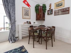 a dining room with a table and chairs at Ismay Billiard Room Apartment - Titanic Interest in Crosby