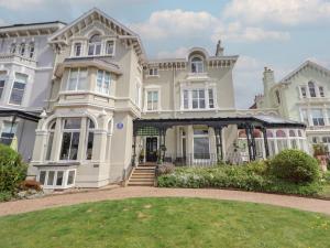 a large house with a lawn in front of it at Ismay Billiard Room Apartment - Titanic Interest in Crosby