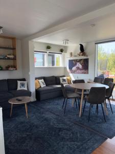 a living room with a couch and a table at Sólvellir Holiday Home in Kjósahreppur