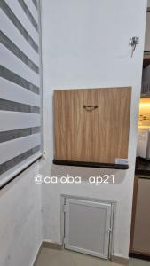 a room with a wooden cabinet on the wall at Caioba com excelente localização in Matinhos +9 photos