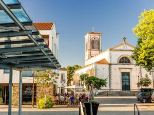 a building with a church with a clock tower at Maison rénovée 3 chambres, proche centre et plage, jardin, parking - FR-1-231-332 in Brétignolles-sur-Mer