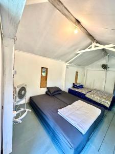 a bedroom with a bed in a tent at Hong Homestay in Pulau Sarang
