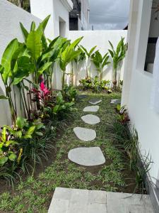 a garden with stepping stones and plants at Honeymoon Villa near Canggu in Badung