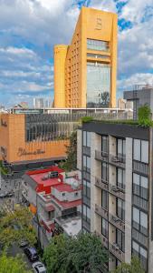 an aerial view of a city with a tall building at Capitalia Palacio Polanco in Mexico City