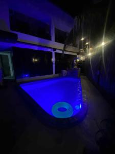 a swimming pool at night with blue lights at Journey Inn in General Luna