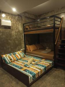 a bed in a room with a bunk bed at Journey Inn in General Luna