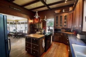 a large kitchen with wooden cabinets and a dining room at Belton Bed and Breakfast in Belton