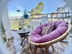 a purple chair sitting on top of a balcony at Blue Windy Đà Lạt Homestay in Da Lat