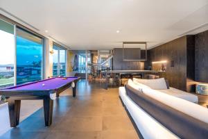 sala de estar con mesa de ping pong de color púrpura en Luxe Haus - Exceptional Views NobleBNB, en Moana