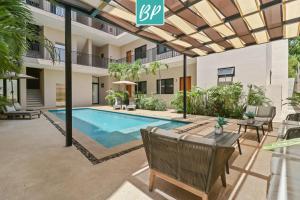 a patio with a swimming pool in a building at Stanza Bucerias Condos - Pool Parking & Near Beach in Bucerías