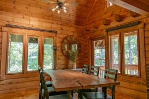 a dining room with a wooden table and chairs at Hakuba Hills Lodge in Hakuba